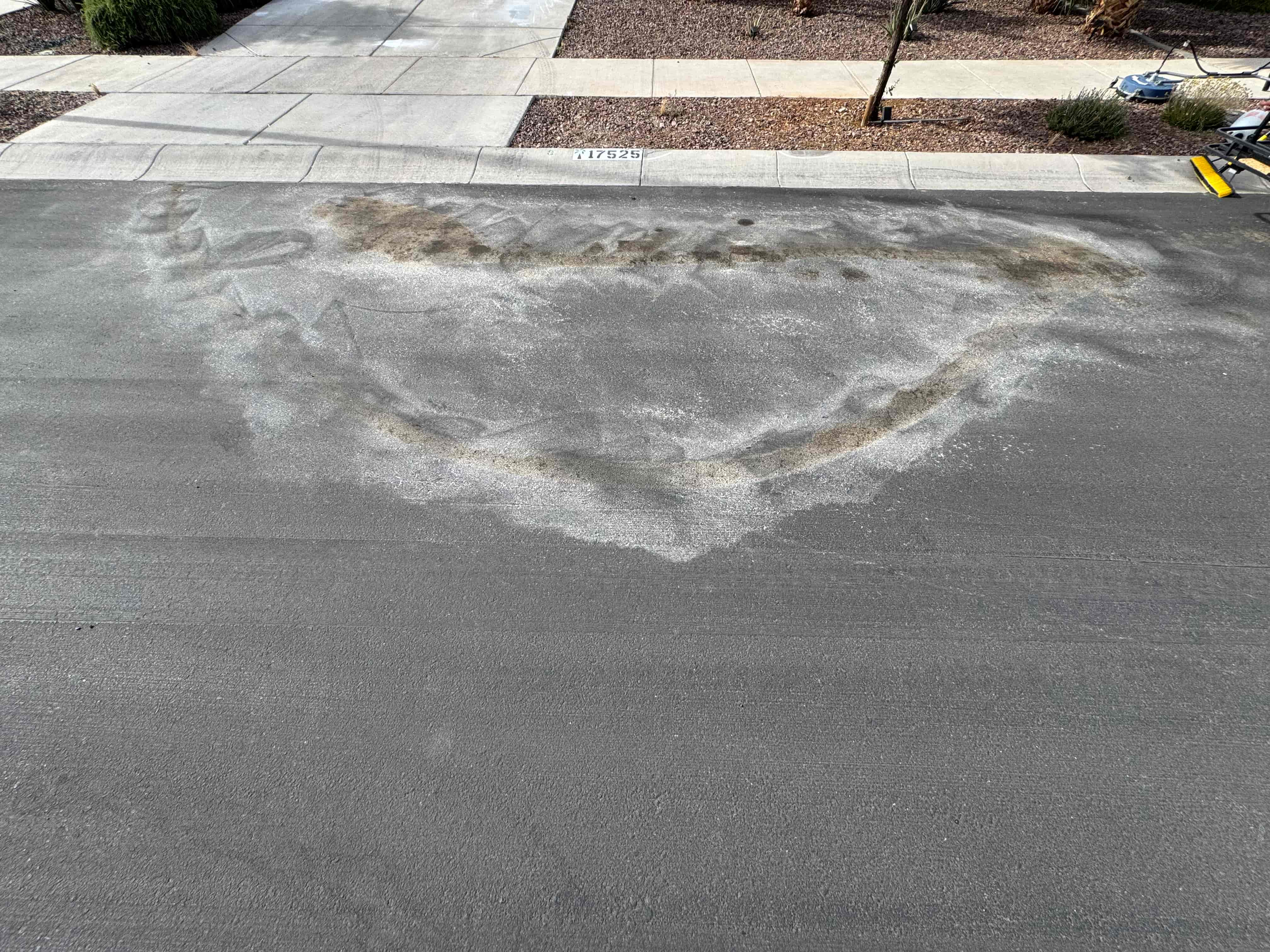 Transmission oil stain on asphalt before cleaning
