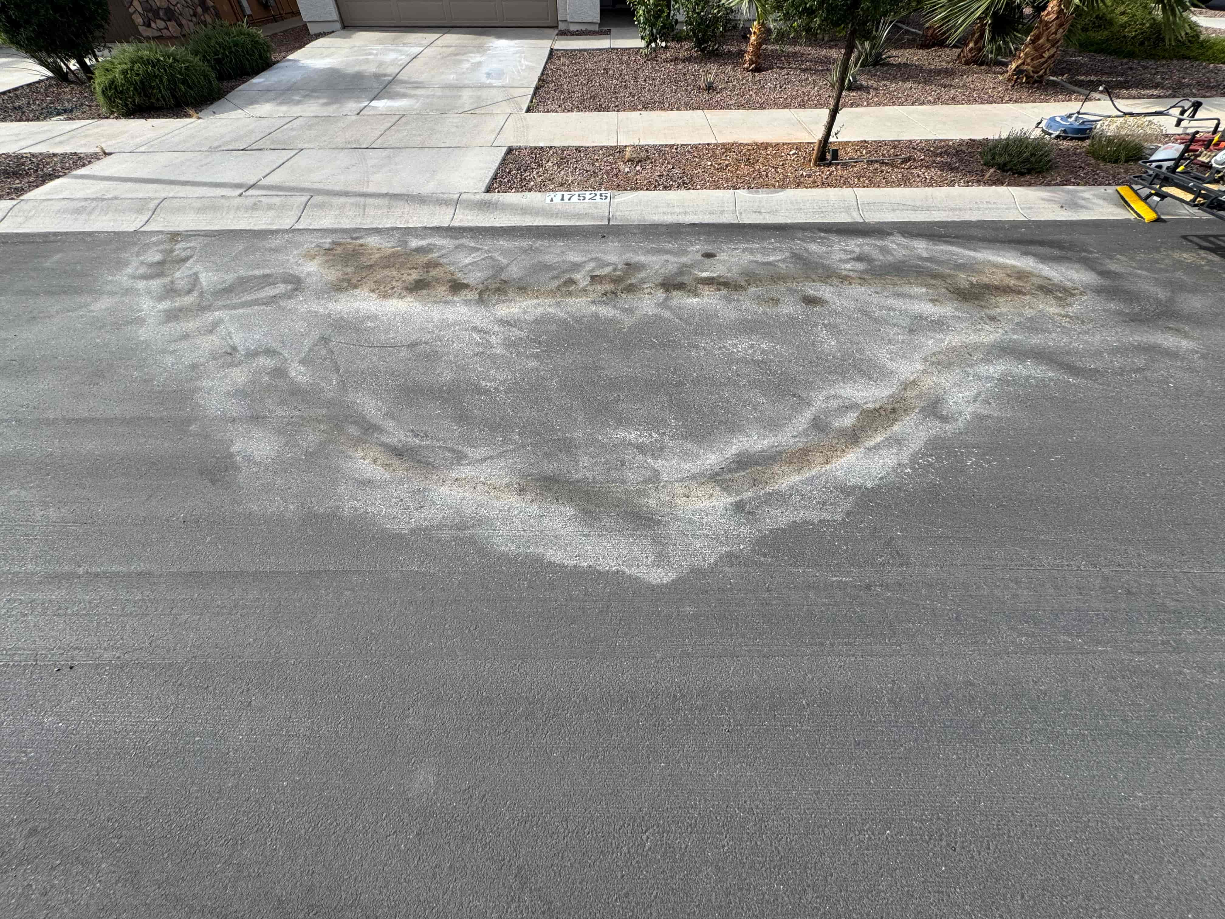 Transmission oil stain on asphalt before cleaning