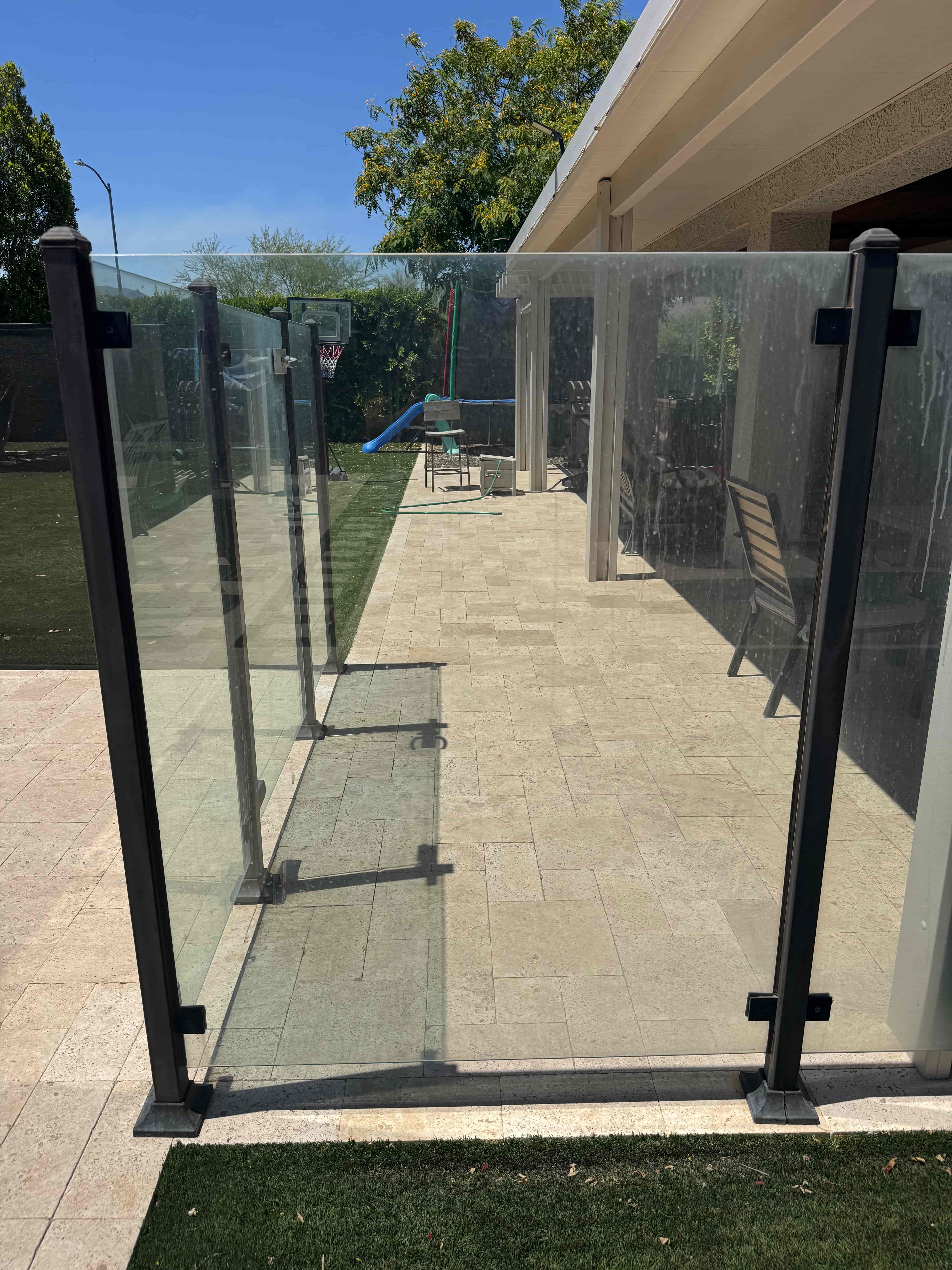 Pool gate glass hard water buildup before cleaning