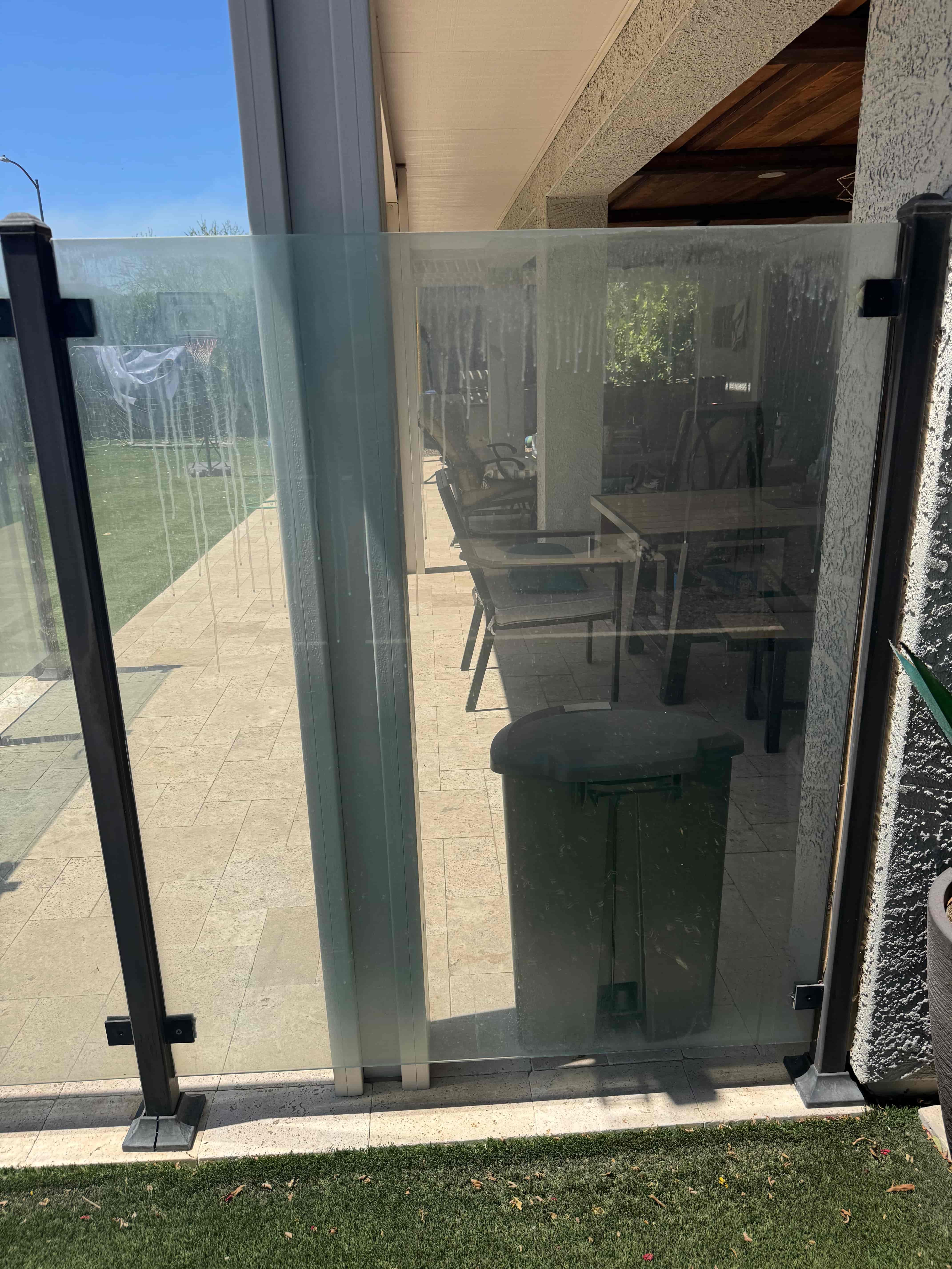 Pool gate glass hard water buildup before cleaning