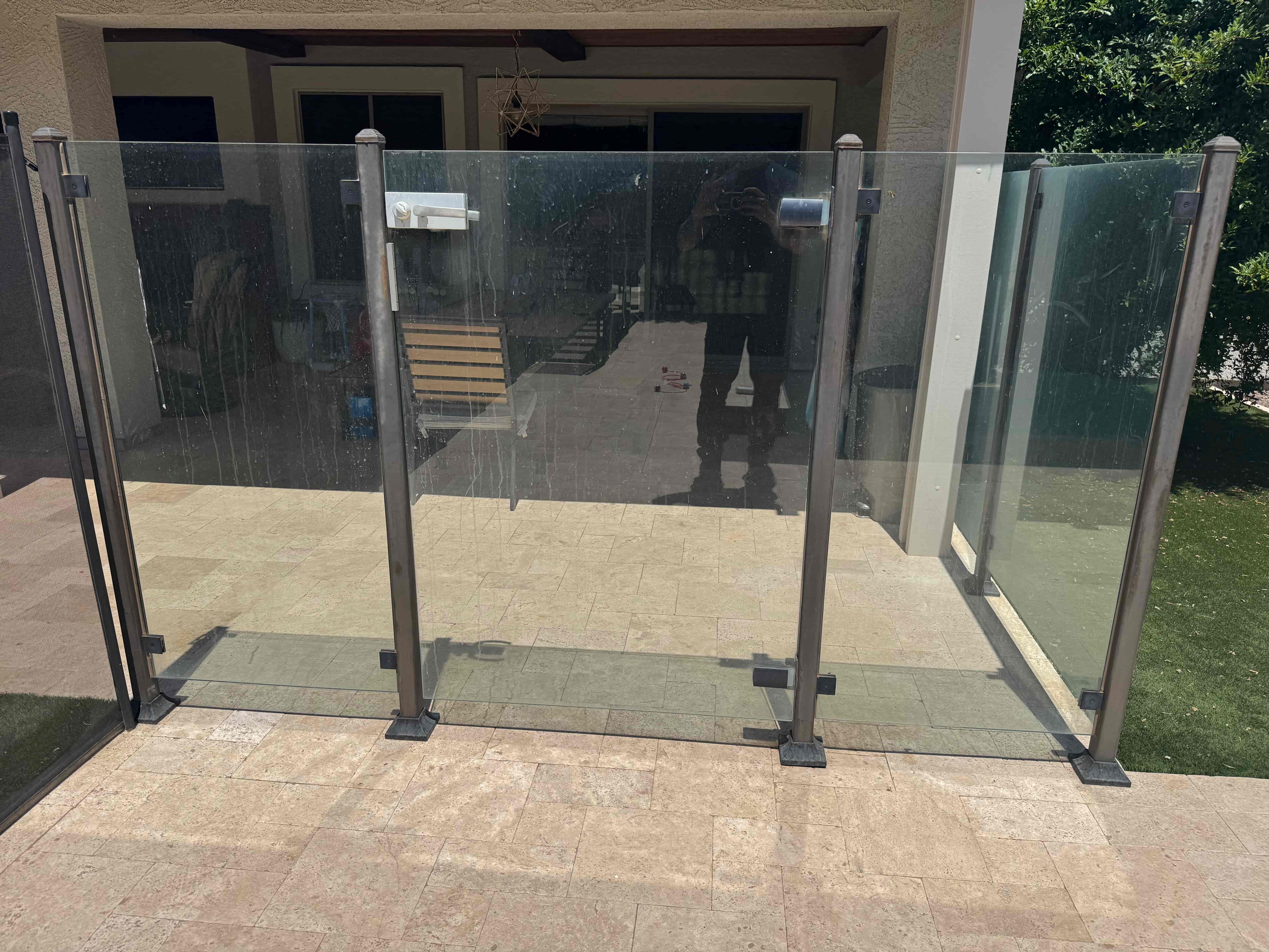Pool gate glass with hard water buildup before cleaning