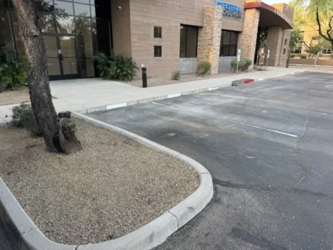 Commercial parking area, sidewalk and curb before exterior cleaning