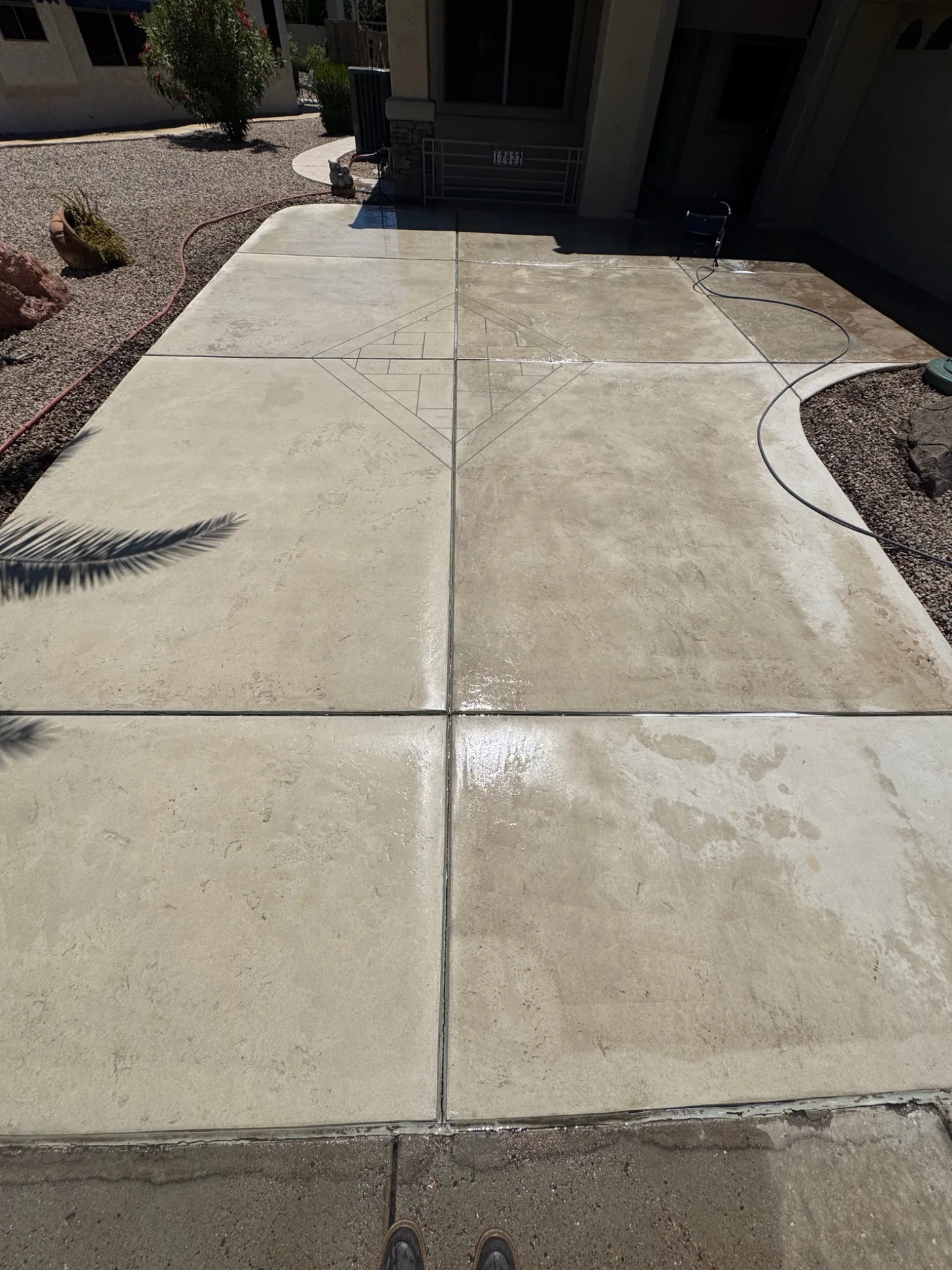 Residential driveway partly cleaned during pressure washing