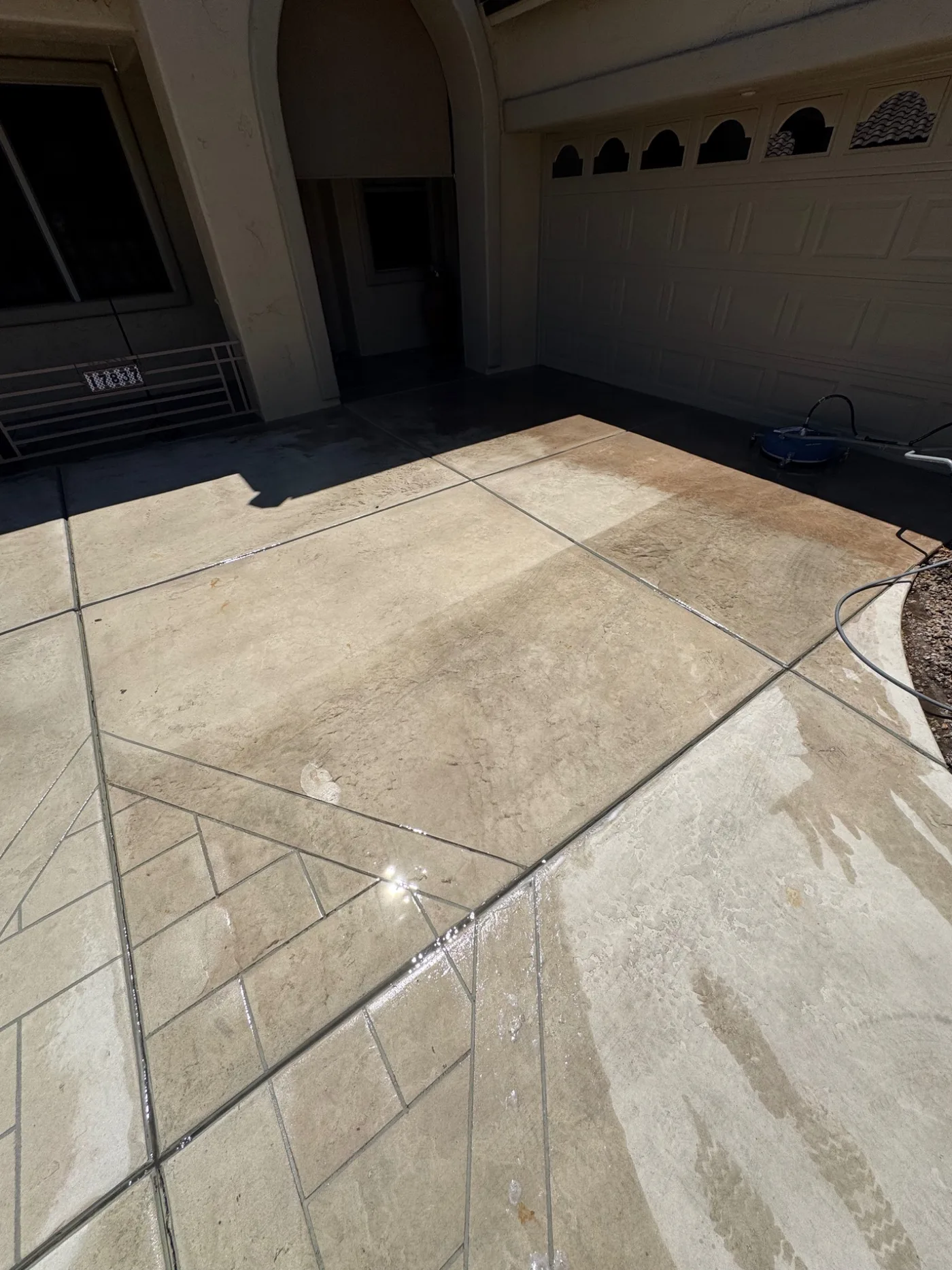 Stark clean and dirty contrast on a residential concrete driveway