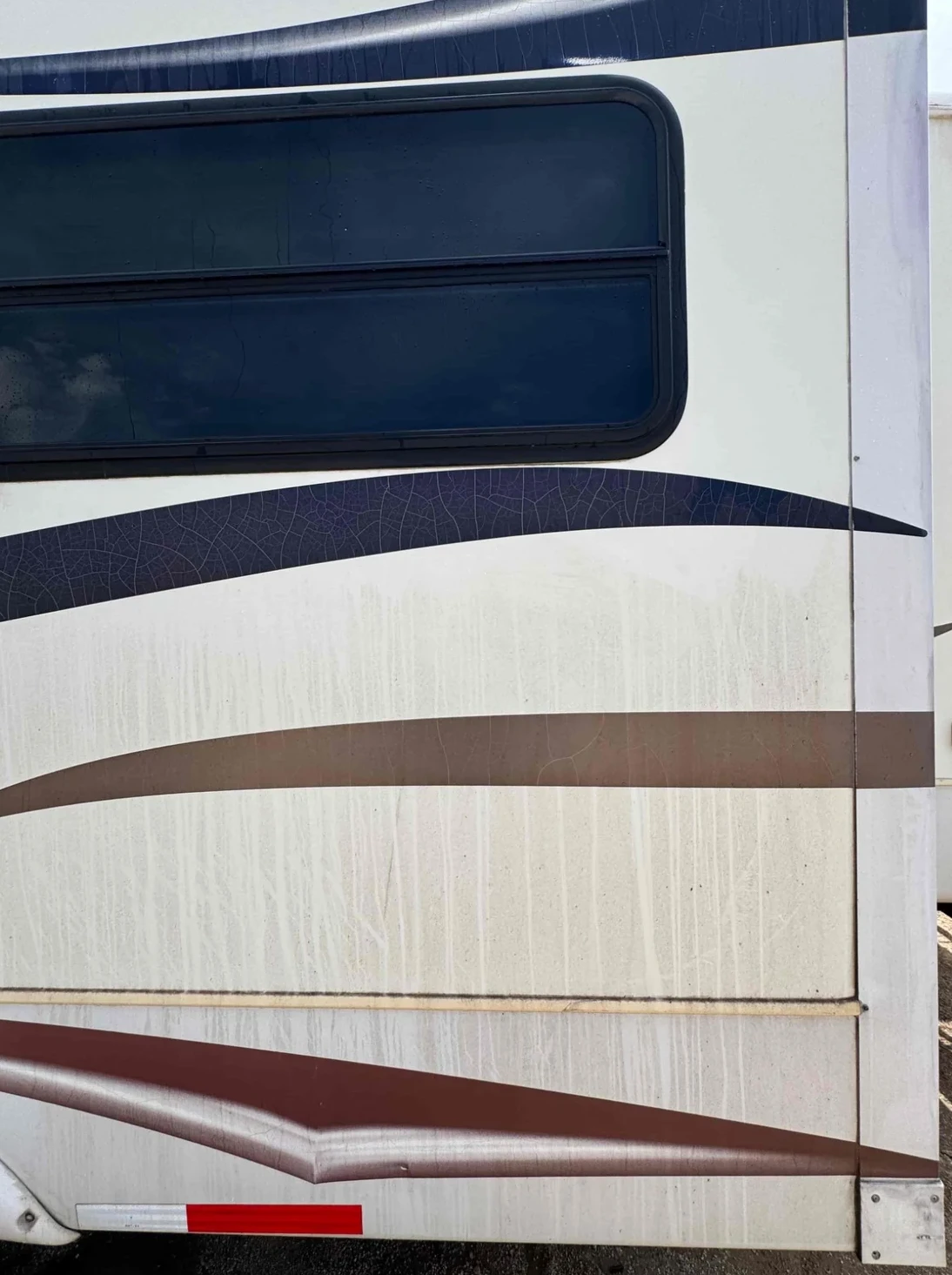RV exterior before washing with visible dirt and streaking