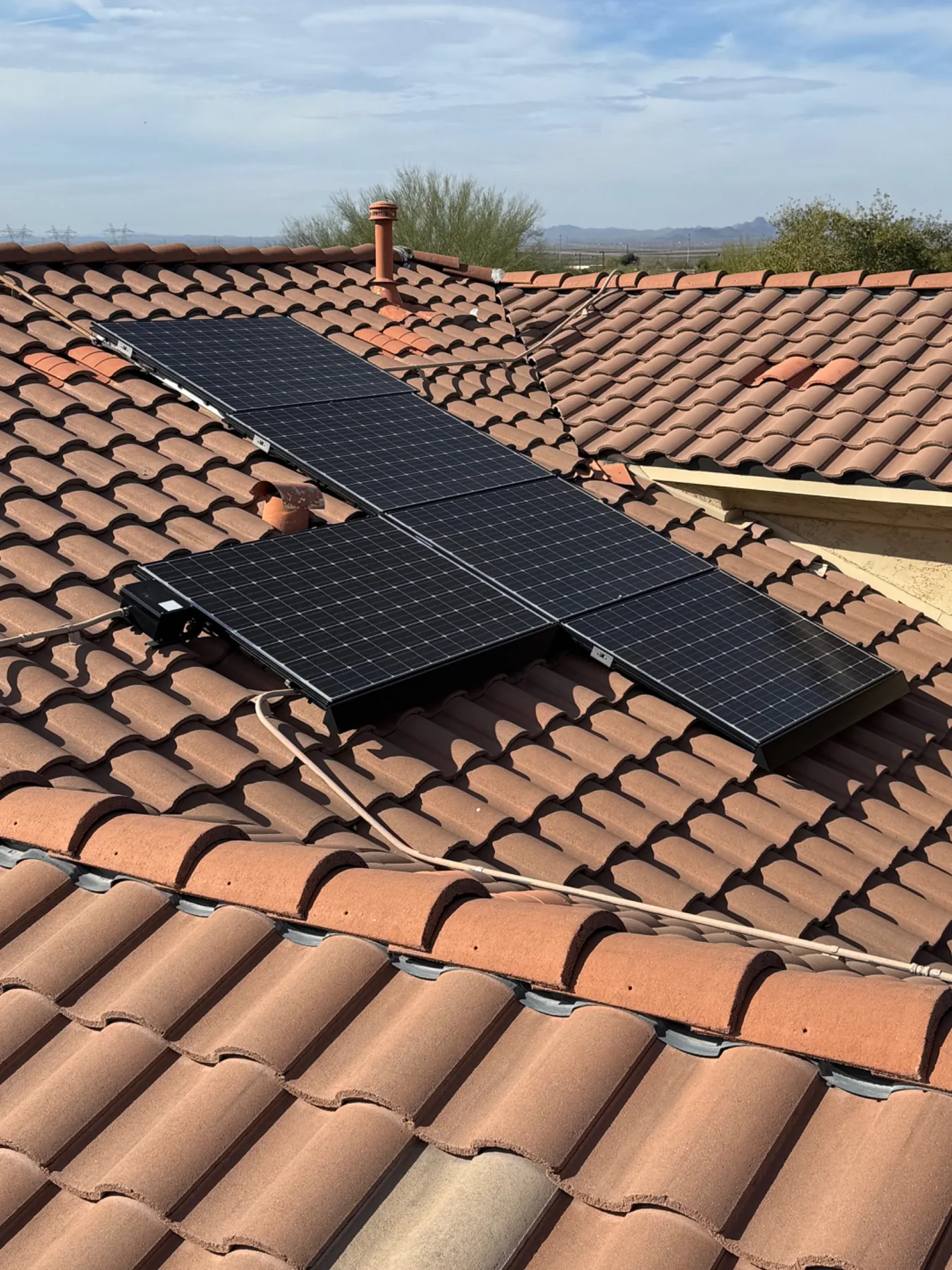 Clean residential solar panel array on an Arizona tile roof